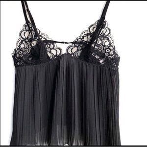 Victoria’s Secret Black camisole 
Features pleated body with lace bra top